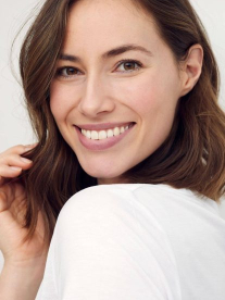 Arca Aesthetics beautiful woman smiling and touching her hair