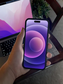 An AI-generated image of a person holding an iPhone in front of a MacBook.