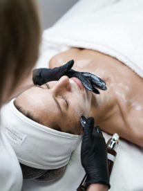 A woman lying in the chair having a medical grade beauty treatment.