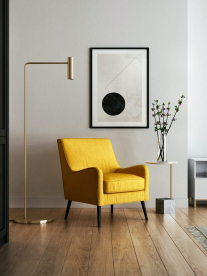 A modern yellow occasional chair in a minimalist lounge.
